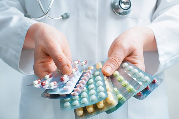 Doctor holding medication blister packs